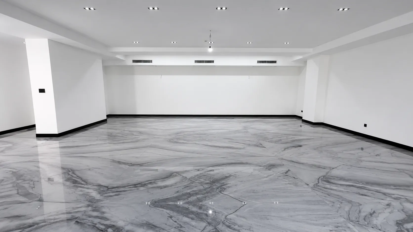 Empty room with a high-gloss grey and white marbled epoxy floor
